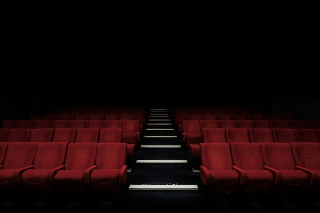 A cinema screen in a dark theatre for FlickHour movie-night guide